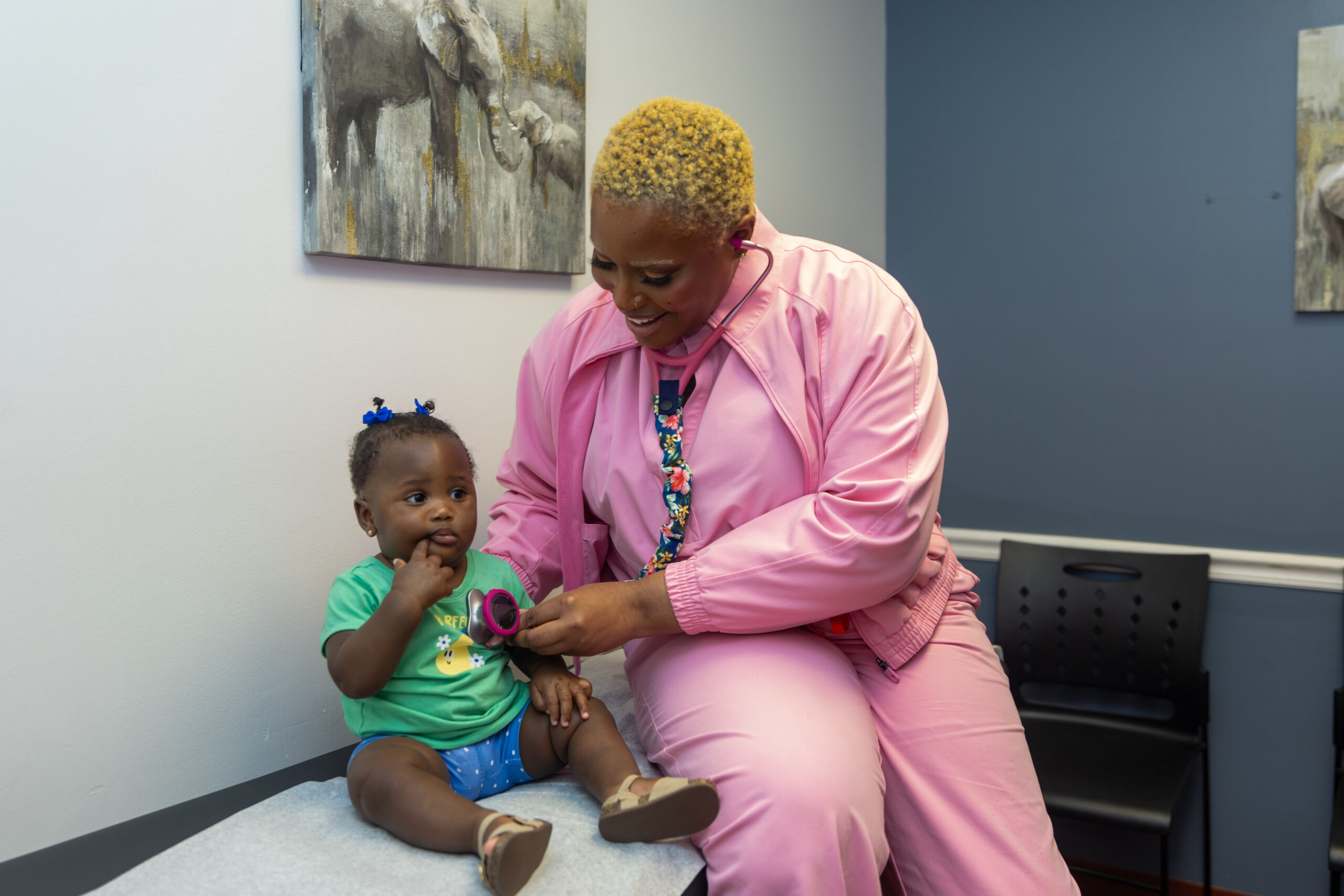 Provider examining infant with stethoscope