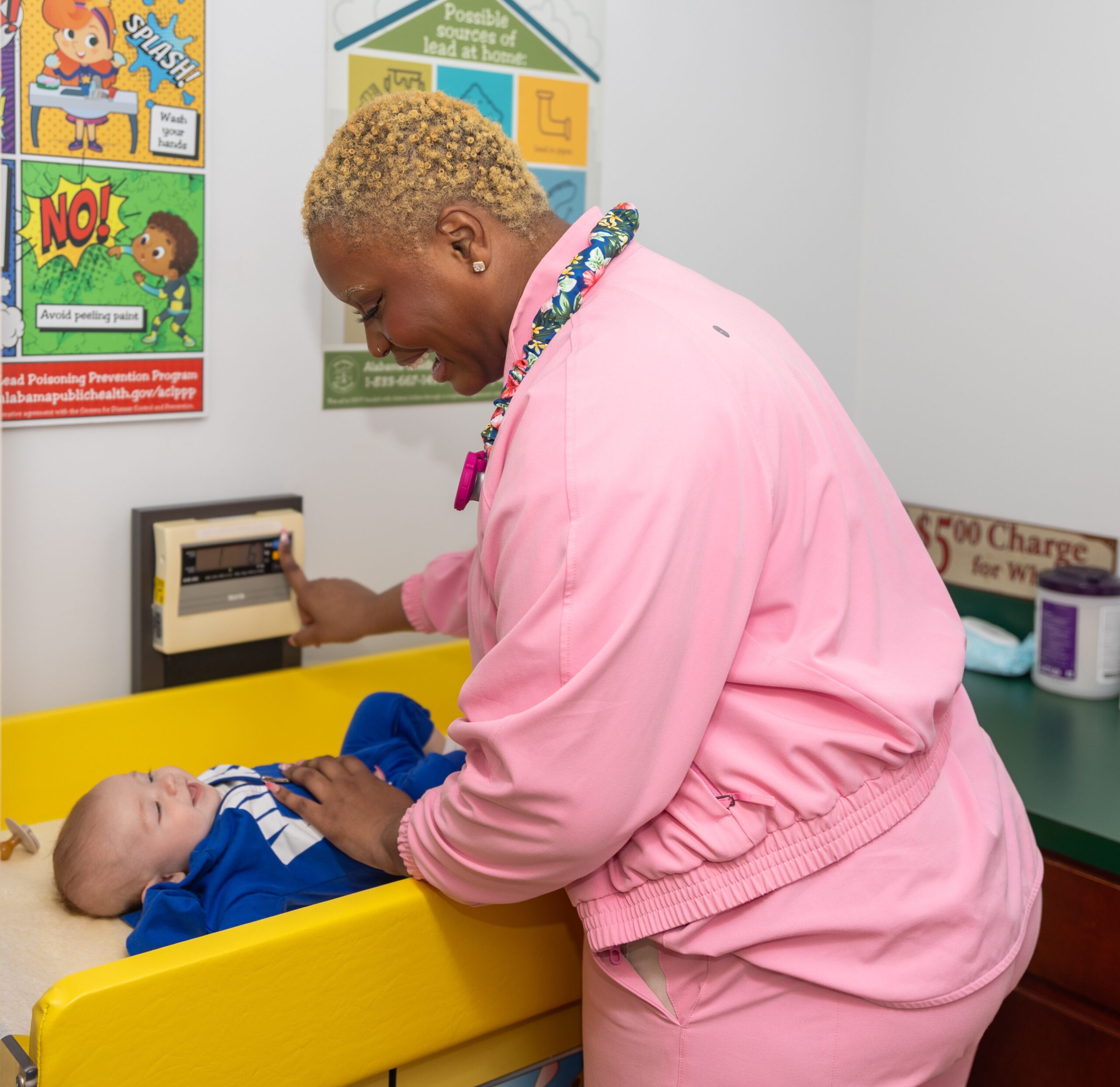 Provider weighing infant